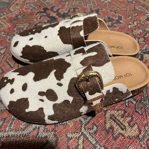 TOP Moda Brown and White Cow Print Clogs with Gold Buckle
